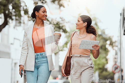 Image of Startup entrepreneurs, female friends or design students discussing fashion project over coffee. Trendy stylish designers or girls walking together to agency in modern urban city with digital tablet