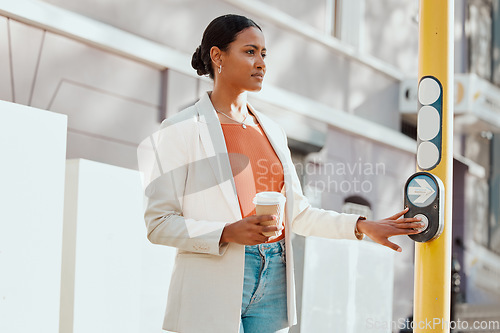 Image of Crossing street, crosswalk or road at a pedestrian traffic light signal while waiting in a city outdoors. Young woman pressing button while traveling, commuting and walking in town on her way to work