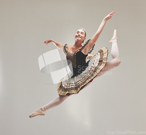 Image of Elegant ballet dancer dancing with a vintage style, jumping and performing in a studio. Portrait of a skilled, talented and young ballerina leaping high in the air enjoying her performance