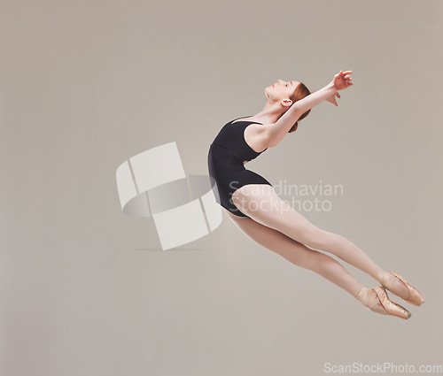 Image of Ballet dancer dancing, training and artistically jumping in the air with flexibility, fitness and performance. Healthy, motion and talented ballerina exercises for a classical act in studio