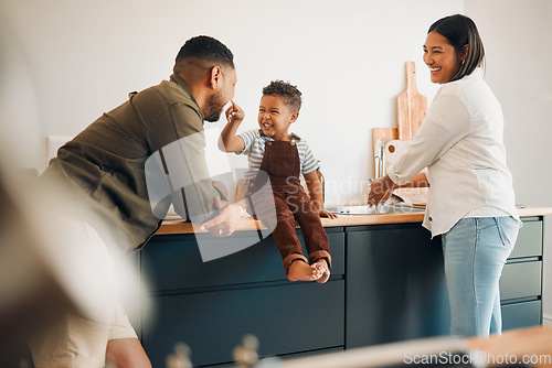 Image of Parents, child and home of a fun, loving and caring family being playful with their son. Funny father making silly faces with his boy while having a laugh together with his wife in a kitchen.