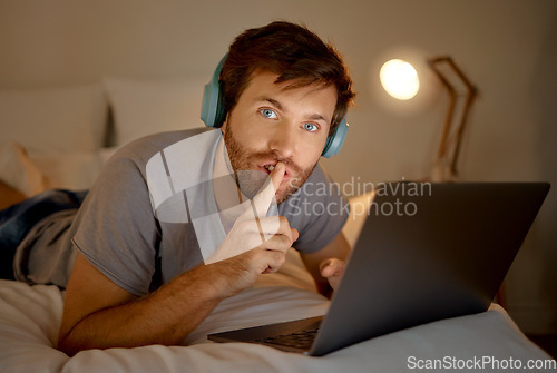 Image of Laptop, portrait and quiet hand gesture from man trying to focus. Insomnia or workaholic reading emails at night in his bedroom. Silence expression from person for silent environment while working.