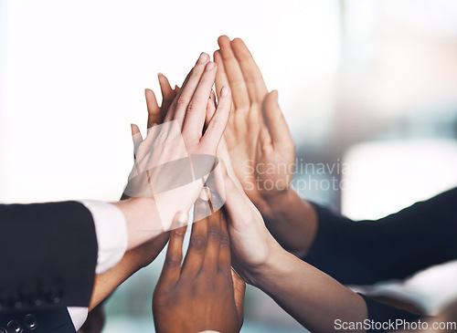 Image of Business people giving high five for motivation, unity, and support in a meeting together at work. Closeup of hands of colleagues and employees huddling to celebrate a success, victory or win