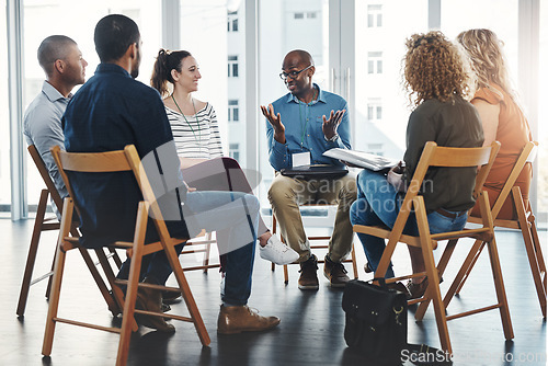 Image of Business people in an informal meeting, team building discussion or group project planning session. Leader, manager or supervisor talking to diverse colleagues or employees about workflow management