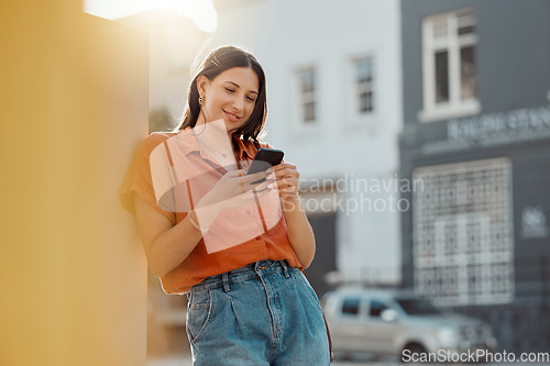 Image of Texting on a phone, waiting for public transport and commuting in the city with a young female tourist enjoying travel and sightseeing. Looking online for places to see and visit while on holiday