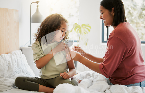 Image of Loving mother comforting her daughter with a bandage in bed, being affectionate and caring at home. Young parent helping her sick child, applying a plaster and bonding, special moments of motherhood