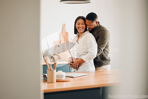 Image of Hugging, happy and excited couple spending quality time together and relaxing at home. Loving, relaxed and affectionate African lovers embracing, cuddling and having fun in the house