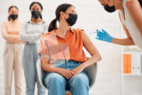 Image of Vaccine, injection and medicine treatment for covid, flu and pandemic disease with nurse, healthcare or medical professional. Stylish, edgy and creative office woman with mask getting injected in arm