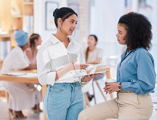 Image of Empowered businesswomen working together on a project in the office. Female employees at work talking, collaborating, and brainstorming. Marketing agency with busy business people browsing technology