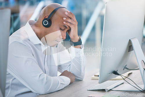 Image of Stressed, tired and headache of working sales consultant, call center agent or customer service advisor. Overworked, worried or frustrated phone operator employee at contact us helpdesk agency