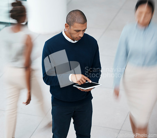 Image of Busy office with business man on tablet browsing, planning and scrolling for online research, mobile notes and digital ideas from above. Organized entrepreneur working on plan in a bustling workplace