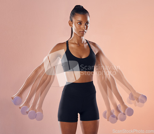 Image of Fitness, workout and training female athlete lifting weights or dumbbells in a studio to stay healthy, active and strong. Wellness, cgi and young woman doing a side lateral raise exercises, portrait