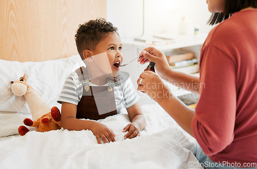 Image of Sick child taking medicine syrup, flu treatment and cold cure for illness, sickness and virus symptoms. Mom caring for health of little son, kid and boy to rest, recover and get better in bed at home