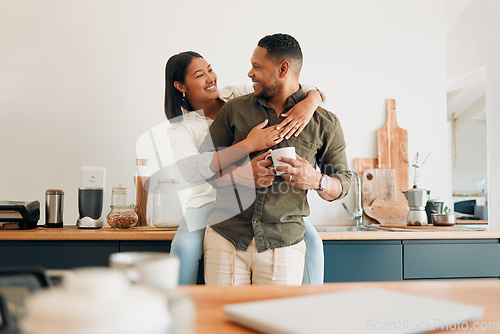 Image of Happy, hugging and romantic couple bonding and feeling united, supported and in love. Cheerful and relaxed married man and woman embracing in home kitchen during morning coffee routine break