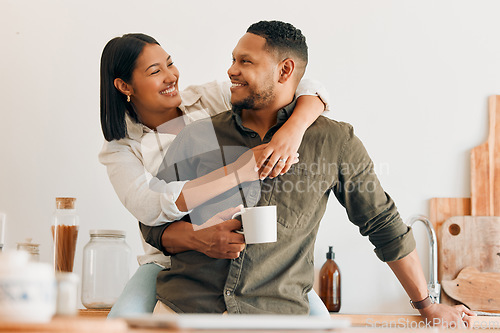 Image of Happy, coffee and loving couple bonding and having fun while spending time together at home. Smiling, in love and carefree couple hugging and sharing a romantic moment while enjoying the weekend