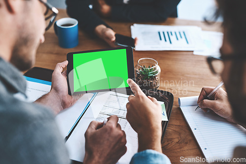 Image of Green screen, copyspace and chromakey on a tablet screen in the hands of a business man in a meeting in a boardroom. Advertising, marketing and online promotion with colleagues pointing at copyspace
