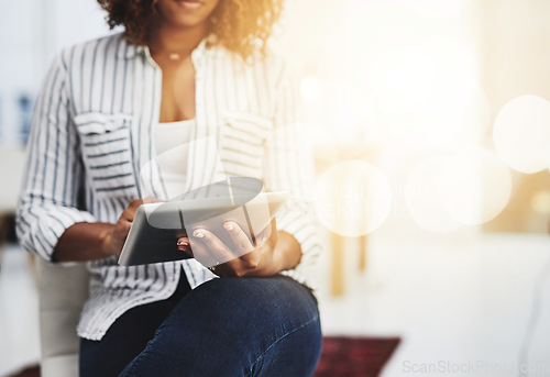 Image of Business woman typing on a tablet, replying to emails and checking notifications while sitting in office at work. Manager, professional worker and creative designer searching the internet for ideas