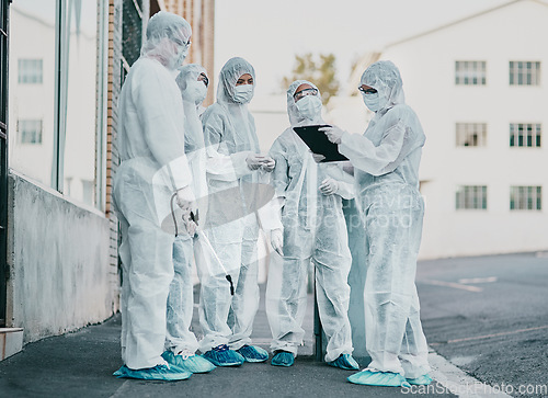 Image of Covid, pandemic and healthcare team wearing protective ppe to prevent virus spread at a quarantine site. First responders wearing hazmat suits while discussing plan for cleaning and disinfecting