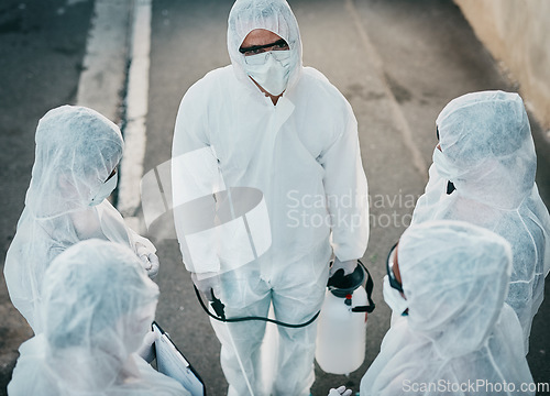 Image of Covid pandemic outbreak team of doctors or medical workers wearing protective ppe to prevent spread of virus outside. Group of scientists wearing hazmat suit for corona or ebola disease in the street