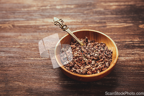 Image of Cocoa bean nibs  in small bowl - baking ingredients