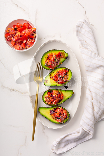 Image of Avocados filled with bruschetta and balsamic vinaigrette - vegan appetizers