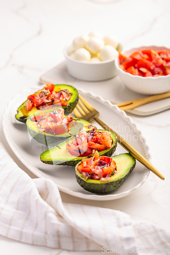 Image of Avocados filled with bruschetta and balsamic vinaigrette - vegan appetizers