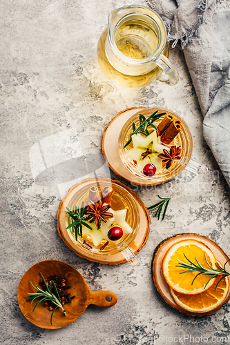 Image of Delicious white mulled wine with apples, cranberries and spices