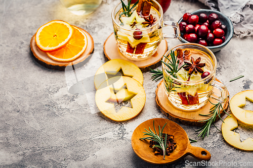 Image of Delicious white mulled wine with apples, cranberries and spices