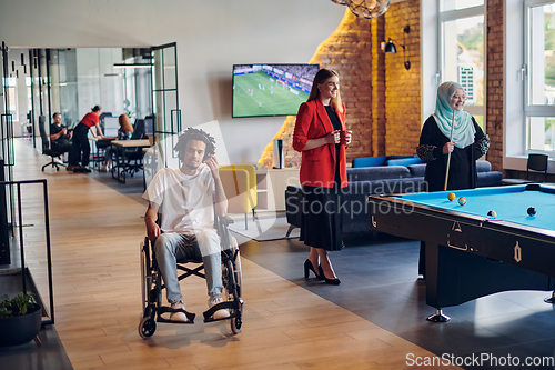 Image of A businessman in a wheelchair occupies a hallway within a modern startup coworking center, embodying inclusivity and determination in the business environment