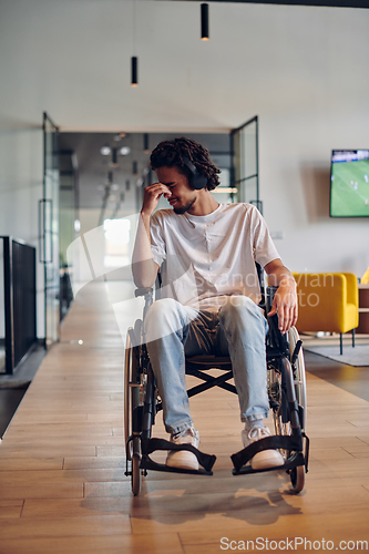 Image of A sad businessman in a wheelchair occupies a hallway within a modern startup coworking center, embodying inclusivity and determination in the business environment