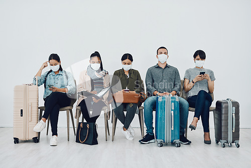Image of Travel and tourism during the pandemic with passengers wearing masks and being safe in an airport waiting line. Group of people in a departure lounge, ready to board and complying with covid protocol