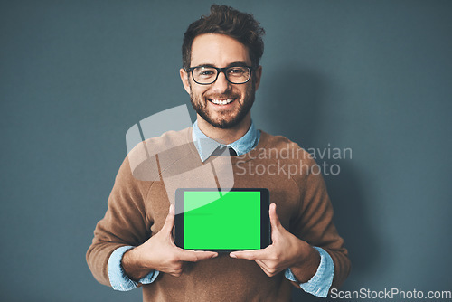 Image of Green screen, copy space and chroma key on tablet monitor for website, marketing and promotion. Portrait of smiling, happy and excited web designer showing new webpage and app on technology in studio