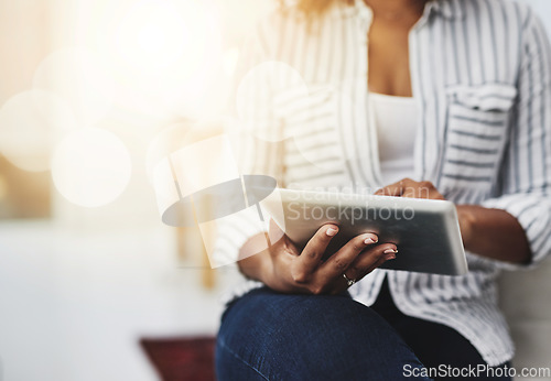 Image of Tablet technology in the hands of a woman browsing social media, surfing the internet or chatting online with flare and copyspace. Closeup of a female sending an email message or reading news