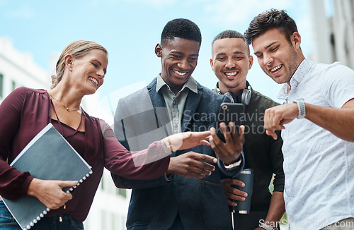 Image of Young, diverse and creative design team and their manager looking at phone together outside from below. Female leader, boss or CEO showing new staff or interns the company website during orientation