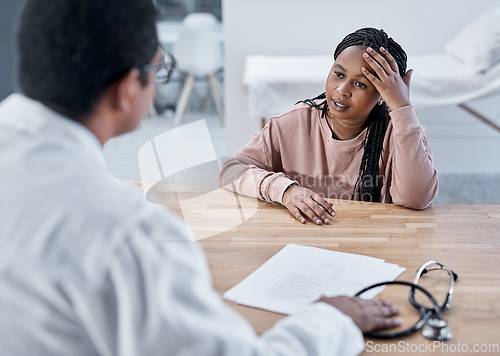 Image of Sick, ill or stressed patient with doctor talking in medical consultation, checkup or visit in clinic, hospital or healthcare center. Tired woman with headache explaining symptoms to professional gp