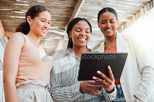 Image of Startup entrepreneur, small business owner and business woman working together as a a team on a tablet from below. Discussing ui and ix ideas while at work with a mindset of growth and teamwork