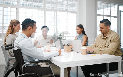 Image of Team analyzes research discussing and marketing data while planning strategy in startup agency. Group of diverse business people sharing ideas together around a table in a marketing office boardroom