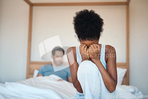 Image of Woman crying after fighting with husband in bedroom at home. Wife sad after husbands affair, lies and cheating in the bed. Depressed couple having relationship problems and decide to get a divorce