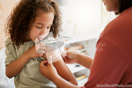 Image of Covid nurse vaccinating child putting a bandage on at a clinic. Doctor applying plaster on girl after an injection at health centre. Pediatric, immunity and prevention at medical childrens hospital