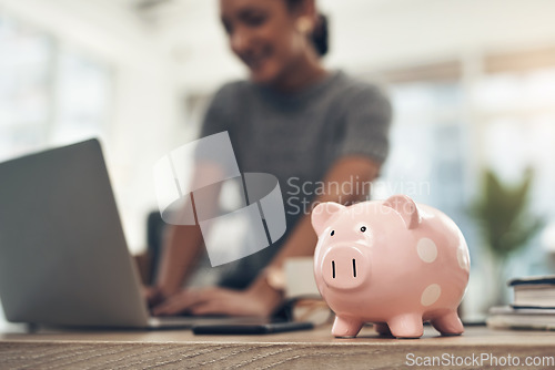 Image of Finance, banking and saving money with piggybank, investing and planning while working on a laptop in an office at work. Managing and growth of budget for insurance, investment and retirement