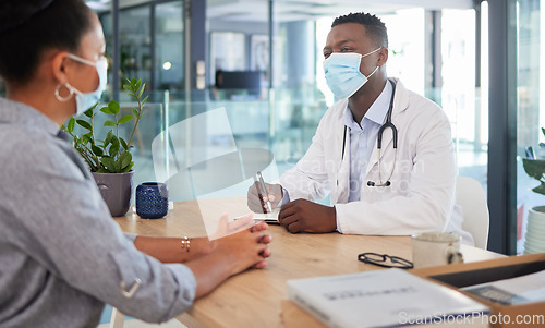 Image of Covid doctor talking to patient for a medical checkup, wellness consult and healthcare screening in a clinic. Trusted gp, physician and essential worker discussing medicine and consulting health