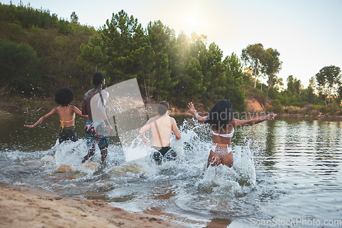 Image of Nature, vacation and friends having fun swimming on lake trip together, enjoying outdoors summer holiday. Young joyful people making a splash in swimwear or bikini on an adventure break