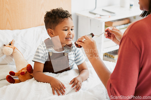 Image of Sick child taking medicine, syrup and treatment for recovery of cold illness, flu sickness and virus symptoms. Mom caring for health of young son, kid and boy to rest in bed for wellness at home