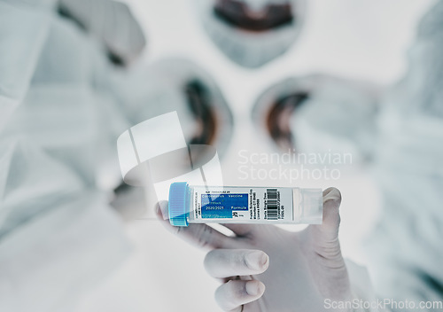 Image of Healthcare scientists holding a vaccine, test tube and medical treatment while doing covid research in a laboratory. Group of science technicians standing together with the cure for corona virus