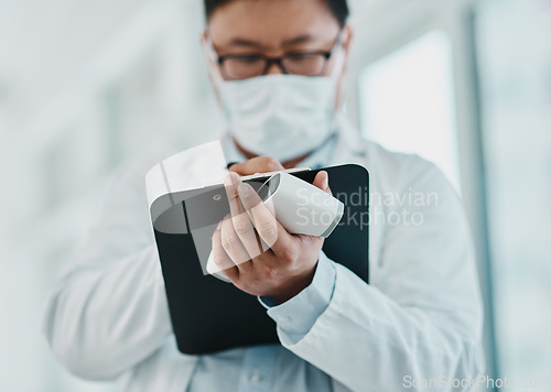 Image of Covid, pandemic and virus, doctor or medical healthcare worker writing on a clipboard. Scientist wearing a mask to prevent the spread of the sickness and keep a checklist of infected patients