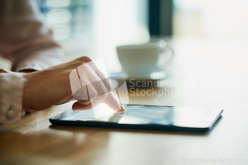 Image of Closeup of business hands working on a digital tablet in a modern office. Professional at work on touch screen browsing the online market for data or information on trading, investment or growth.