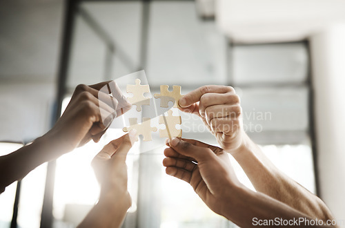 Image of Business people hands with puzzle showing solution, problem solving and teamwork. Smart group or team activity completing, finishing a task project or assignment in difficult challenging work crisis