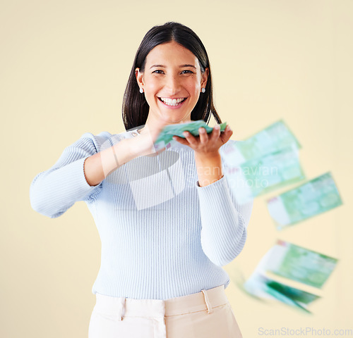 Image of . Wealthy, rich and happy woman throwing money smiling about her financial success and freedom. Portrait of an excited young female having fun and enjoying her cash and ready to spend.