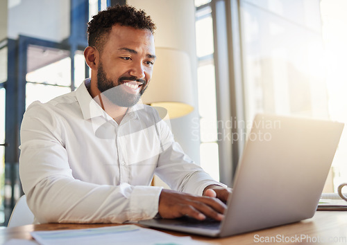 Image of Laptop, business and technology with a corporate man at work on a computer at his desk in an office. Innovation, mission and vision with an employee working with motivation and focus toward a goal.