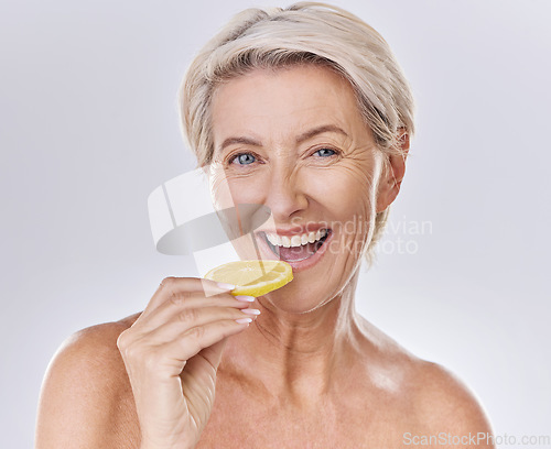 Image of Health, nutrition and wellness of a mature woman happy in her aging skin care, beauty and face. Portrait of an old female model with a lemon promote a healthy natural lifestyle for skincare benefits